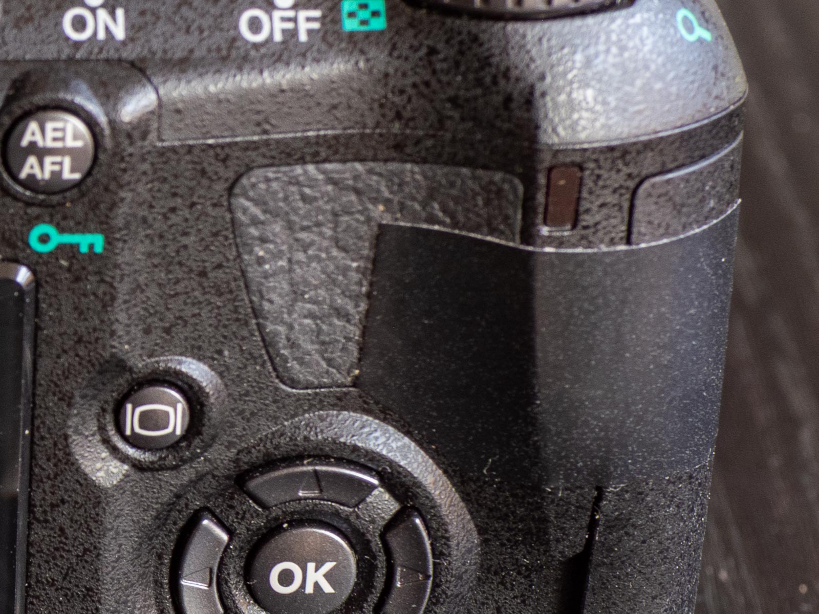 Black electrical tape holding the battery door closed