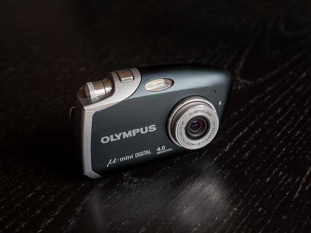 Olympus Mju Mini Digital in black, front and switched on