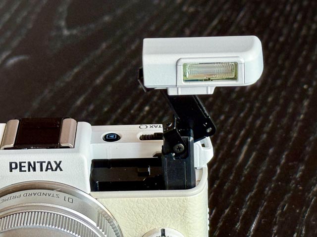 Pentax Q with flash raised.